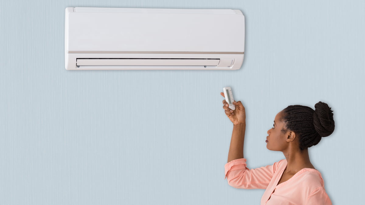Young woman turns on her R22 refrigerant air conditioning system