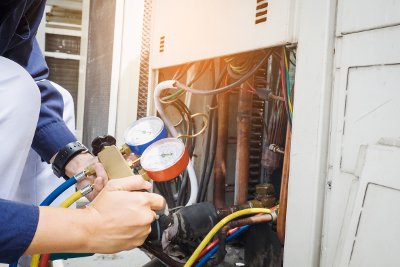 Professional checks an air conditioning unit