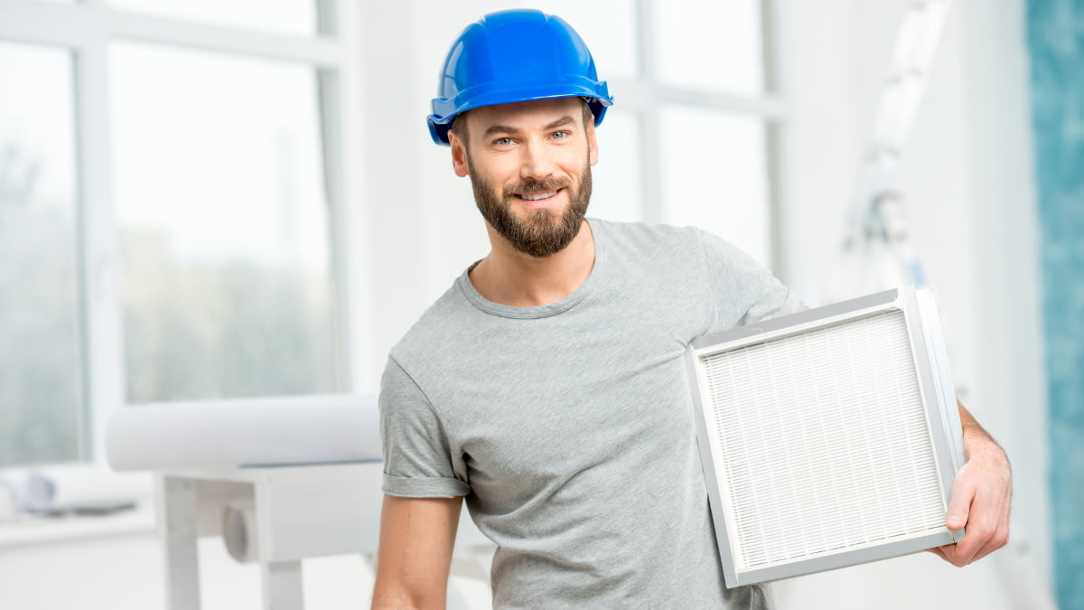 Engineer carries out air conditioning servicing