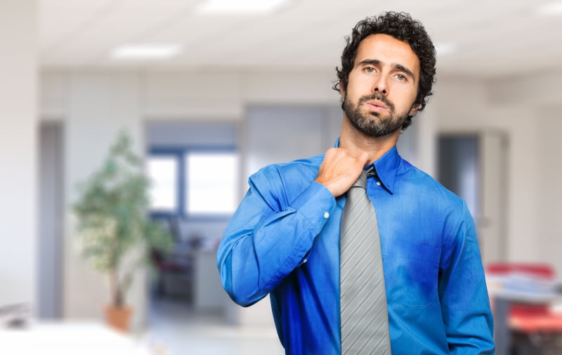 businessman sweating due to no office air conditioning