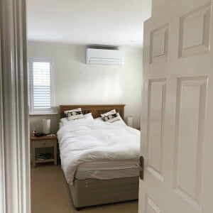 bedroom with air con above bed taken from doorway