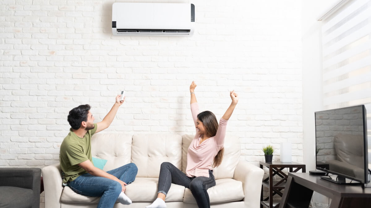 couple celebrating having air conditioning at home