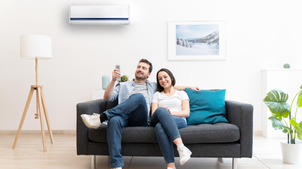 couple sitting above one of the top air conditioners