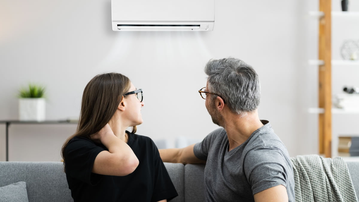 couple looking back at air con unit
