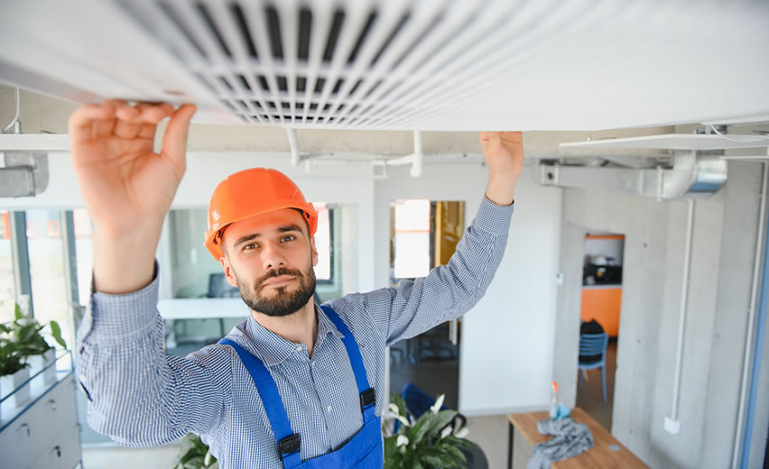 Male Technician Installing Air Conditioner.